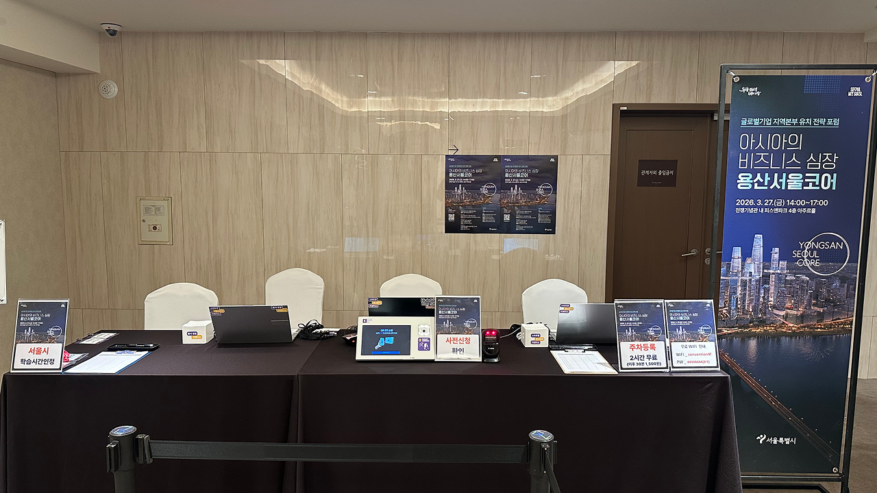 이벤터스 명찰출력 기기와 QR리더기가 설치된 등록데스크, 사전신청 확인 안내판이 배치된 모습